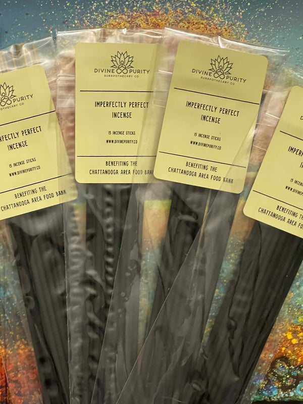 Incense sticks in clear packaging with 'Divine Purity' labels on a colorful background
