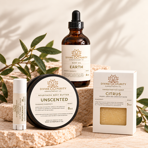 Earth body oil, Unscented body butter, boxed Citrus soap, and Peppermint lip balm on warm cream stone