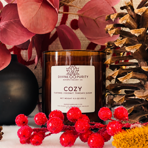 Divine Purity Cozy candle with red berries, burgundy leaves and a pinecone