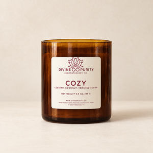 Divine Purity Cozy candle on a warm cream background with a soft shadow