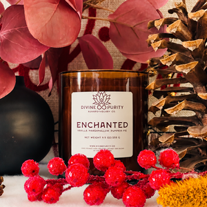 Divine Purity Enchanted candle with red berries, burgundy leaves and a pinecone