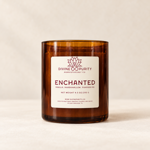Divine Purity Enchanted candle on a warm cream background with a soft shadow