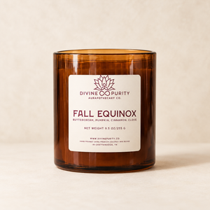 Divine Purity Fall Equinox candle on a warm cream background with a soft shadow