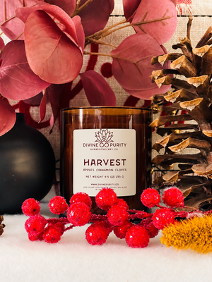Divine Purity Harvest candle with red berries, burgundy leaves and a pinecone