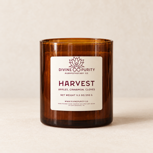 Divine Purity Harvest candle on a warm cream background with a soft shadow