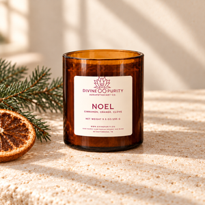 Noel amber candle on warm cream stone with fir and dried orange