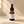 Earth half-ounce mini body oil on warm limestone