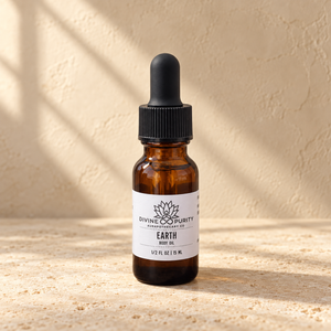Earth half-ounce mini body oil on warm limestone